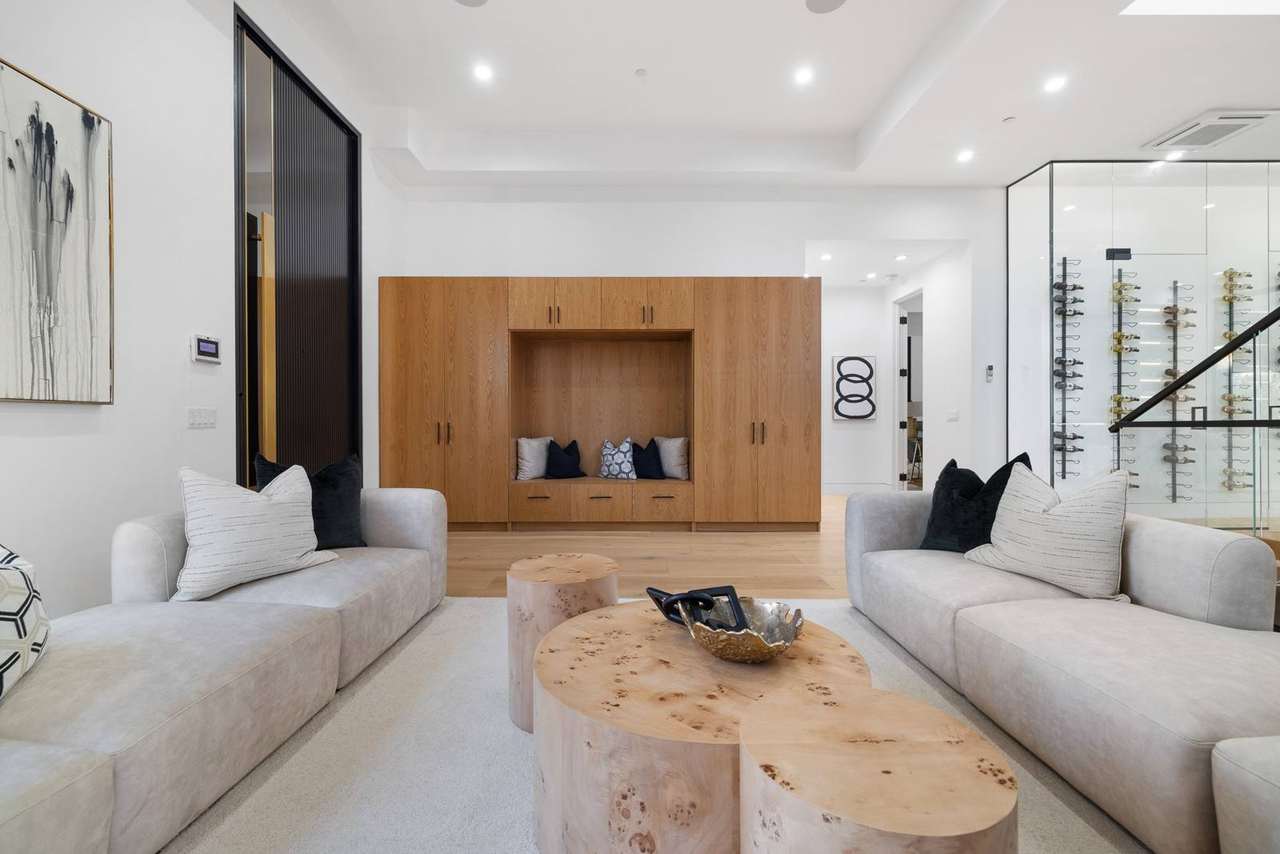 Integrated living room storage wall with custom built-in cabinetry